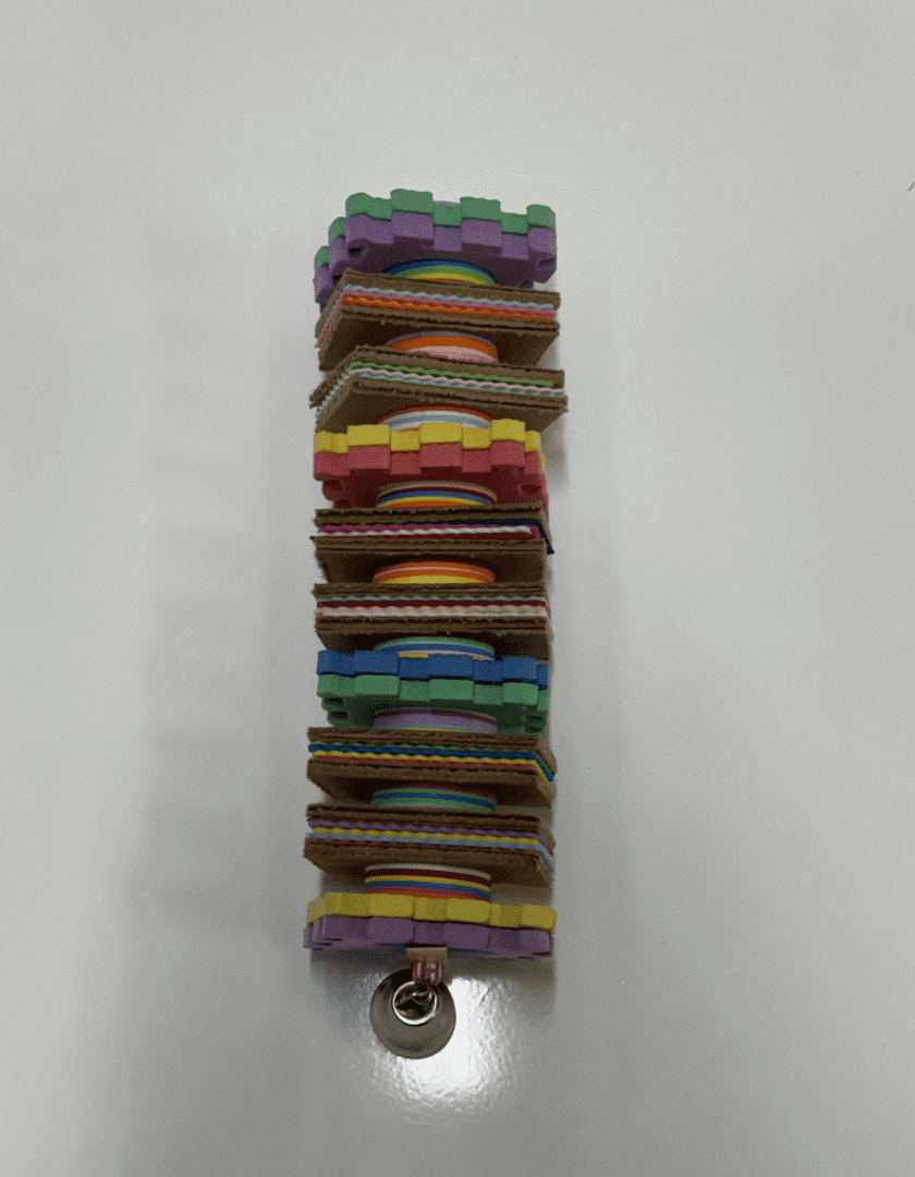 A stack of colorful Puzzler blocks on a white surface.
